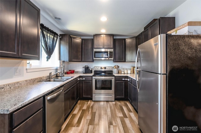 585 Finnegan Rdg, Friday Harbor, WA 98250 - kitchen featuring stainless steel appliances, light wood finished floors, dark brown cabinets, recessed lighting, and light countertops