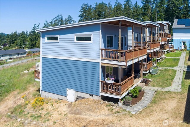 585 Finnegan Rdg, Friday Harbor, WA 98250 - rear view of house with a wooden deck and crawl space