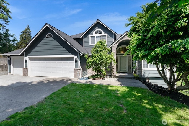 11207 16th St E, Edgewood, WA 98372 - view of front of house featuring driveway, a garage, a front lawn, and brick siding