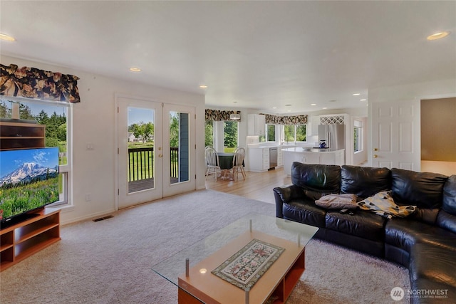 11207 16th St E, Edgewood, WA 98372 - living room with french doors, recessed lighting, and light colored carpet