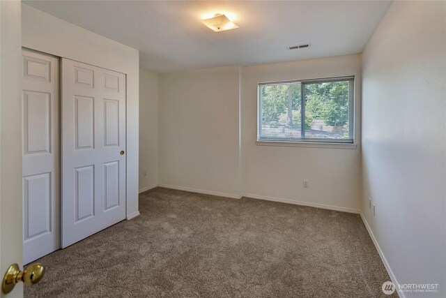 11207 16th St E, Edgewood, WA 98372 - unfurnished bedroom featuring carpet floors, a closet, and baseboards