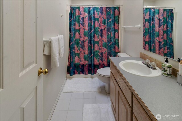 11207 16th St E, Edgewood, WA 98372 - full bathroom with vanity, toilet, tile patterned floors, a shower with shower curtain, and baseboards
