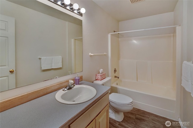 11207 16th St E, Edgewood, WA 98372 - bathroom featuring vanity, toilet,  shower combination, and wood finished floors