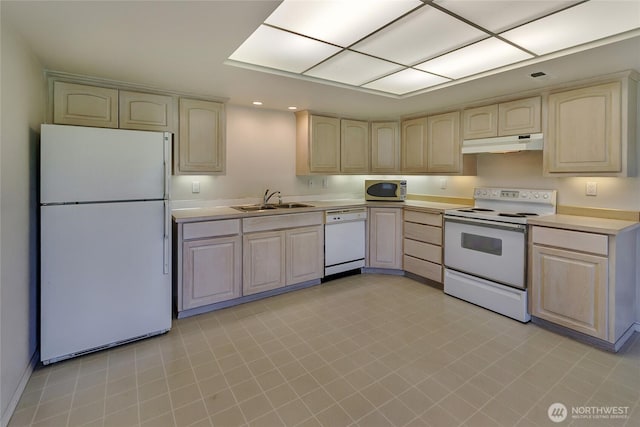 11207 16th St E, Edgewood, WA 98372 - kitchen with white appliances, under cabinet range hood, a sink, light countertops, and light brown cabinets