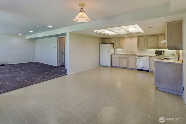 11207 16th St E, Edgewood, WA 98372 - kitchen featuring white appliances, light countertops, a sink, light brown cabinetry, and baseboards