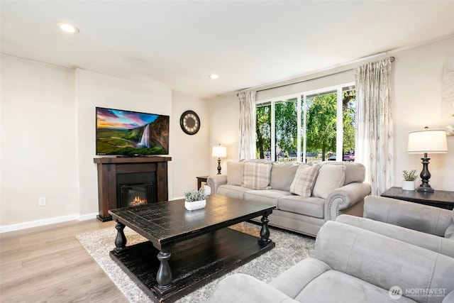 1980 Mckinley St, Enumclaw, WA 98022 - living room with light wood-style flooring, a glass covered fireplace, and recessed lighting