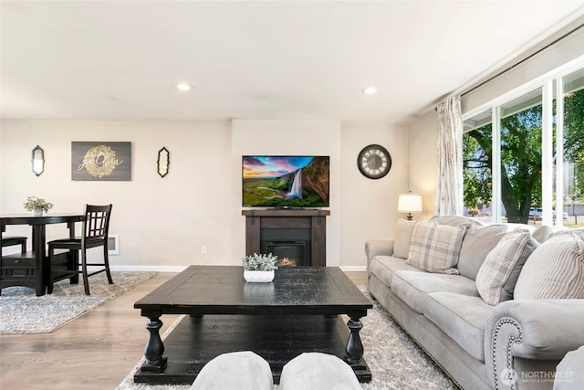 1980 Mckinley St, Enumclaw, WA 98022 - living area with wood finished floors, a glass covered fireplace, and recessed lighting