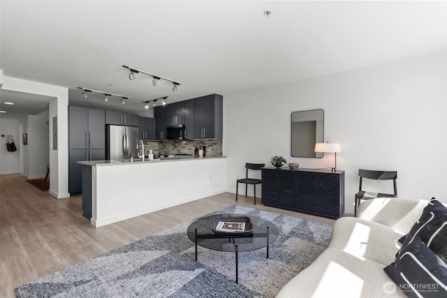 17 W Mercer St Unit 216, Seattle, WA 98119 - living room with light wood-style floors and baseboards