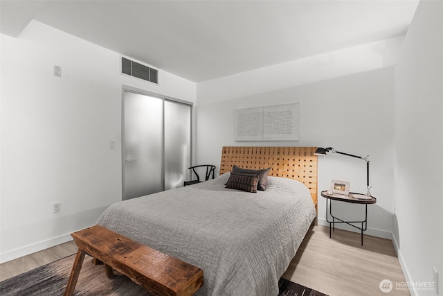 17 W Mercer St Unit 216, Seattle, WA 98119 - bedroom featuring wood finished floors, a closet, and baseboards