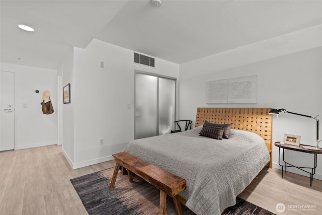 17 W Mercer St Unit 216, Seattle, WA 98119 - bedroom featuring a closet, light wood-type flooring, and baseboards