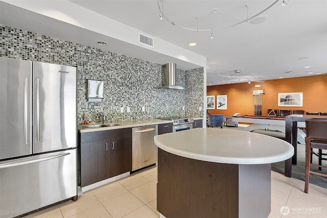 1501 Tacoma Ave S Unit 404, Tacoma, WA 98402 - kitchen featuring appliances with stainless steel finishes, wall chimney exhaust hood, light tile patterned floors, a sink, and recessed lighting