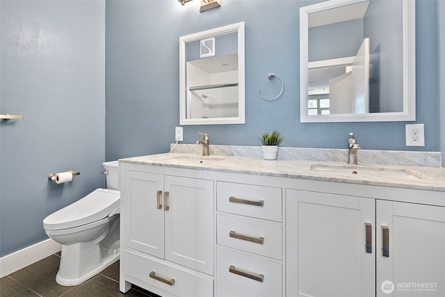 1501 Tacoma Ave S Unit 404, Tacoma, WA 98402 - bathroom with double vanity, toilet, baseboards, and a shower