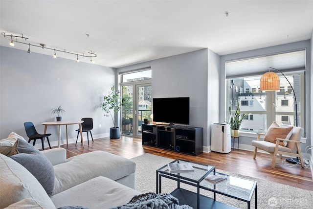 1501 Tacoma Ave S Unit 404, Tacoma, WA 98402 - living area with wood finished floors, baseboards, and track lighting