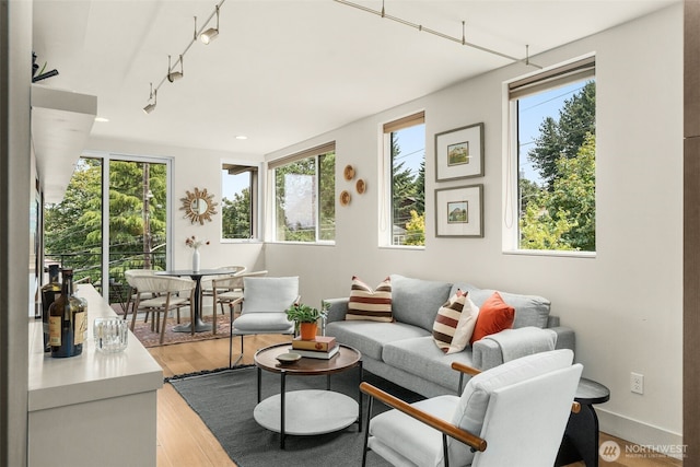 402 W Fulton St, Seattle, WA 98119 - living area featuring healthy amount of natural light, light wood finished floors, track lighting, and recessed lighting