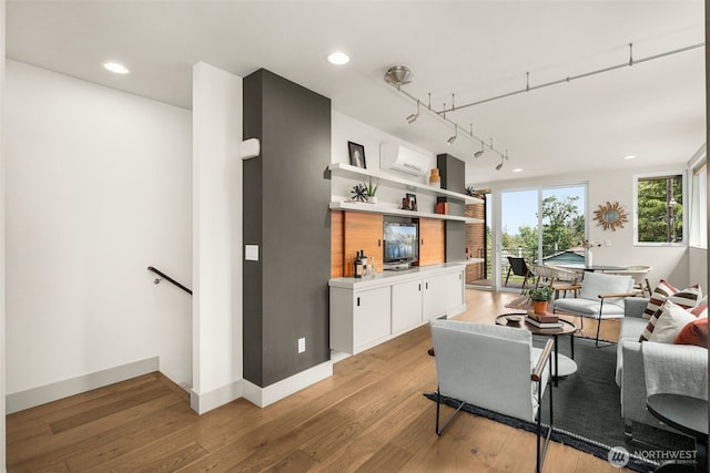 402 W Fulton St, Seattle, WA 98119 - living area with light wood-style flooring, a wall mounted air conditioner, recessed lighting, and rail lighting