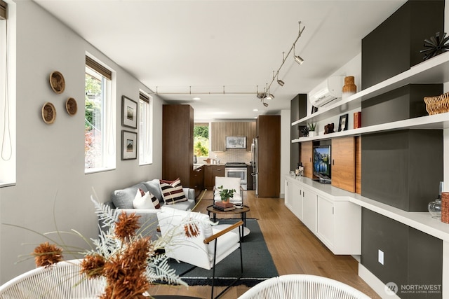 402 W Fulton St, Seattle, WA 98119 - living room featuring a wall unit AC and light wood-style flooring