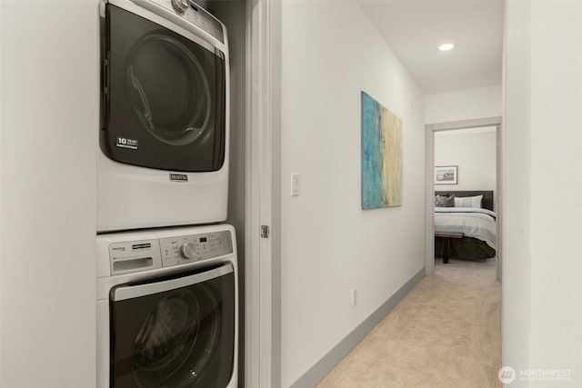 402 W Fulton St, Seattle, WA 98119 - laundry room featuring estacked washer and dryer, light colored carpet, and recessed lighting