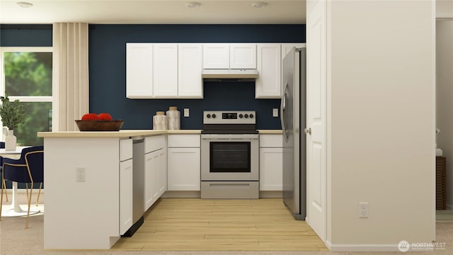 14005 198th St E, Graham, WA 98338 - kitchen featuring appliances with stainless steel finishes, under cabinet range hood, light wood-style flooring, white cabinets, and a peninsula