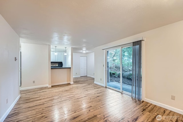 4601 SW 320th St Unit K4, Federal Way, WA 98023 - unfurnished living room with light wood-style floors and baseboards