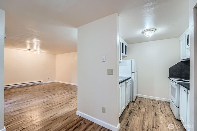 4601 SW 320th St Unit K4, Federal Way, WA 98023 - kitchen with baseboard heating, white appliances, light wood-style flooring, white cabinetry, and dark countertops