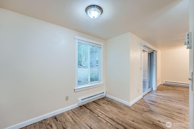 4601 SW 320th St Unit K4, Federal Way, WA 98023 - spare room with a baseboard radiator, baseboards, and light wood finished floors