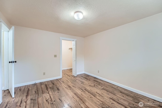 4601 SW 320th St Unit K4, Federal Way, WA 98023 - spare room featuring light wood-style flooring, baseboards, and a textured ceiling