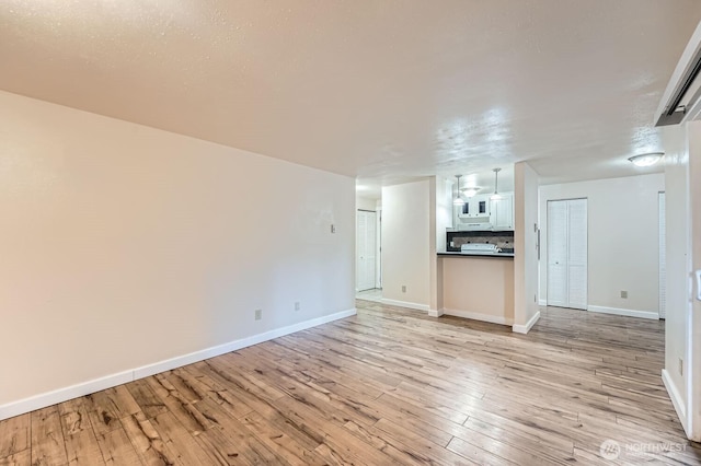4601 SW 320th St Unit K4, Federal Way, WA 98023 - unfurnished living room featuring light wood-style flooring and baseboards