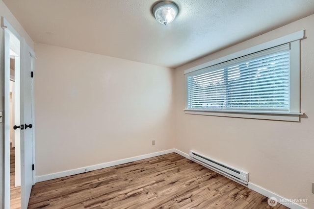 4601 SW 320th St Unit K4, Federal Way, WA 98023 - empty room featuring baseboard heating, wood finished floors, and baseboards