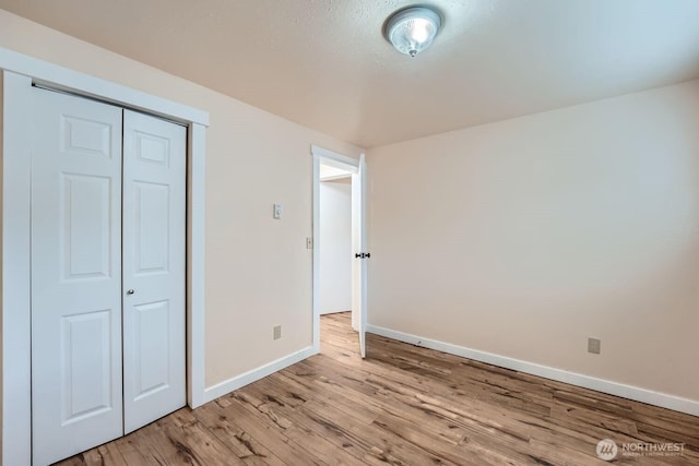 4601 SW 320th St Unit K4, Federal Way, WA 98023 - unfurnished bedroom with baseboards, light wood-style flooring, and a closet