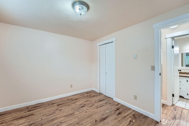 4601 SW 320th St Unit K4, Federal Way, WA 98023 - unfurnished bedroom featuring light wood-type flooring, a closet, and baseboards