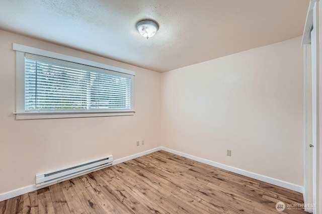4601 SW 320th St Unit K4, Federal Way, WA 98023 - unfurnished room with baseboard heating, wood finished floors, baseboards, and a textured ceiling