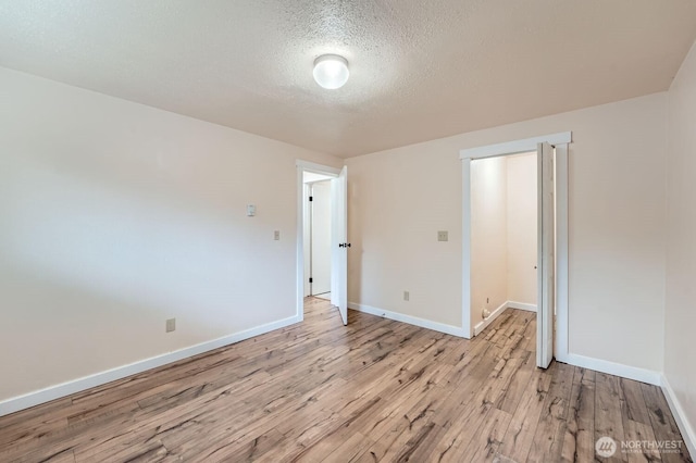 4601 SW 320th St Unit K4, Federal Way, WA 98023 - unfurnished room featuring light wood-style floors, a textured ceiling, and baseboards