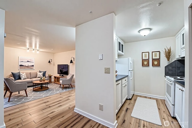 4601 SW 320th St Unit K4, Federal Way, WA 98023 - kitchen with white appliances, light wood-type flooring, white cabinetry, open floor plan, and dark countertops