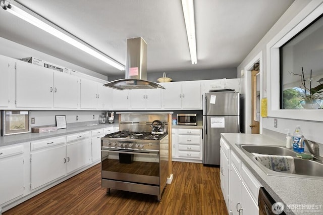 1402 22nd St NE Unit 515, Auburn, WA 98002 - kitchen with island range hood, stainless steel appliances, dark wood-type flooring, light countertops, and white cabinetry