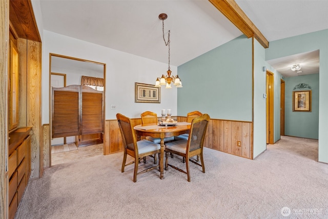 1402 22nd St NE Unit 515, Auburn, WA 98002 - carpeted dining space featuring a wainscoted wall, a chandelier, and wooden walls