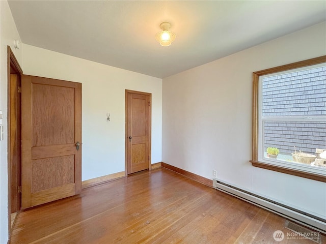 1025 W 6th St, Port Angeles, WA 98363 - unfurnished room featuring a baseboard radiator, light wood-type flooring, and baseboards