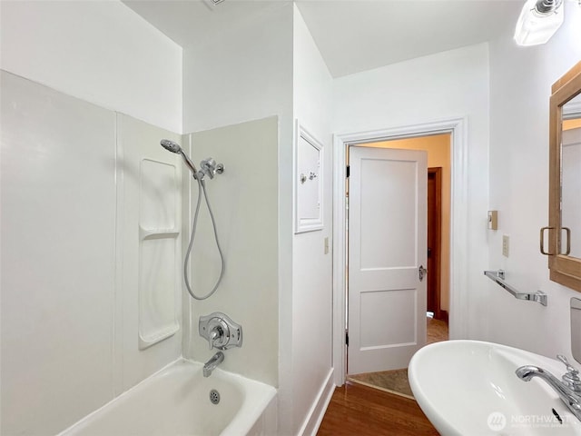 1025 W 6th St, Port Angeles, WA 98363 - full bath with tub / shower combination, a sink, baseboards, and wood finished floors