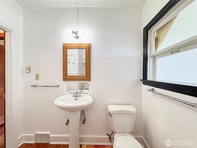 1025 W 6th St, Port Angeles, WA 98363 - bathroom featuring toilet, baseboards, and wood finished floors
