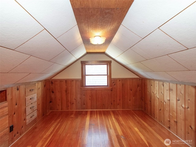 1025 W 6th St, Port Angeles, WA 98363 - additional living space with light wood-type flooring, wooden walls, vaulted ceiling, and wainscoting