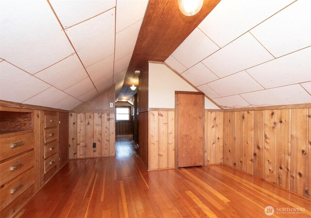 1025 W 6th St, Port Angeles, WA 98363 - additional living space with wood-type flooring, wooden walls, and vaulted ceiling