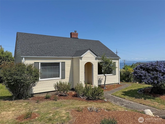 1025 W 6th St, Port Angeles, WA 98363 - cape cod house featuring a chimney and a shingled roof