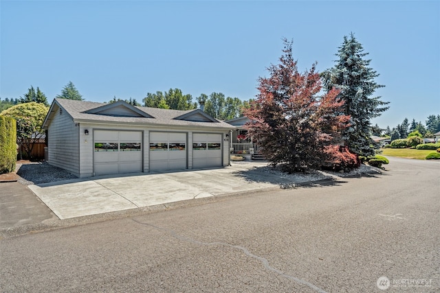 1402 22nd St NE Unit 438, Auburn, WA 98002 - garage featuring concrete driveway