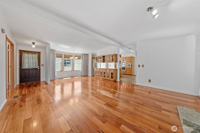 1402 22nd St NE Unit 438, Auburn, WA 98002 - unfurnished living room with a chandelier and light wood-style floors