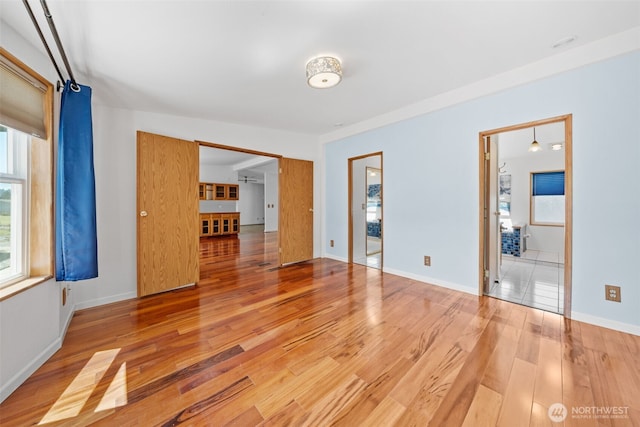 1402 22nd St NE Unit 438, Auburn, WA 98002 - unfurnished bedroom featuring light wood finished floors and multiple windows