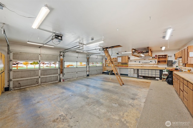 1402 22nd St NE Unit 438, Auburn, WA 98002 - garage with a garage door opener and a workshop area