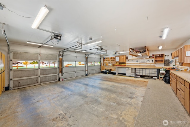 1402 22nd St NE Unit 438, Auburn, WA 98002 - garage with a garage door opener and a workshop area