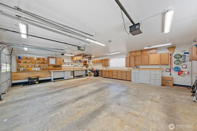 1402 22nd St NE Unit 438, Auburn, WA 98002 - garage featuring a garage door opener and a workshop area