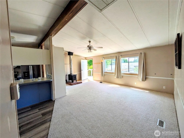201 Hemlock St, Orcas Island, WA 98245 - unfurnished living room featuring a wood stove and ceiling fan