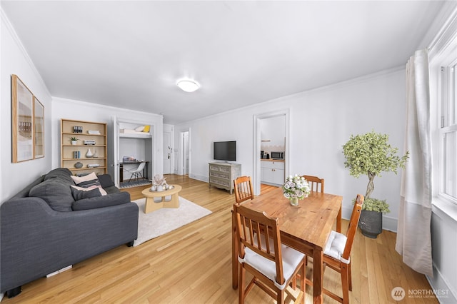 4725 15th Ave NE Unit 37, Seattle, WA 98105 - dining space featuring ornamental molding, light wood finished floors, and baseboards