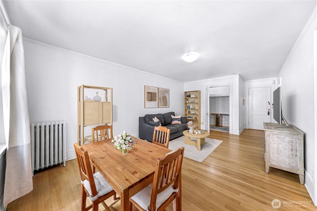 4725 15th Ave NE Unit 37, Seattle, WA 98105 - dining space featuring radiator heating unit, light wood-style flooring, and ornamental molding